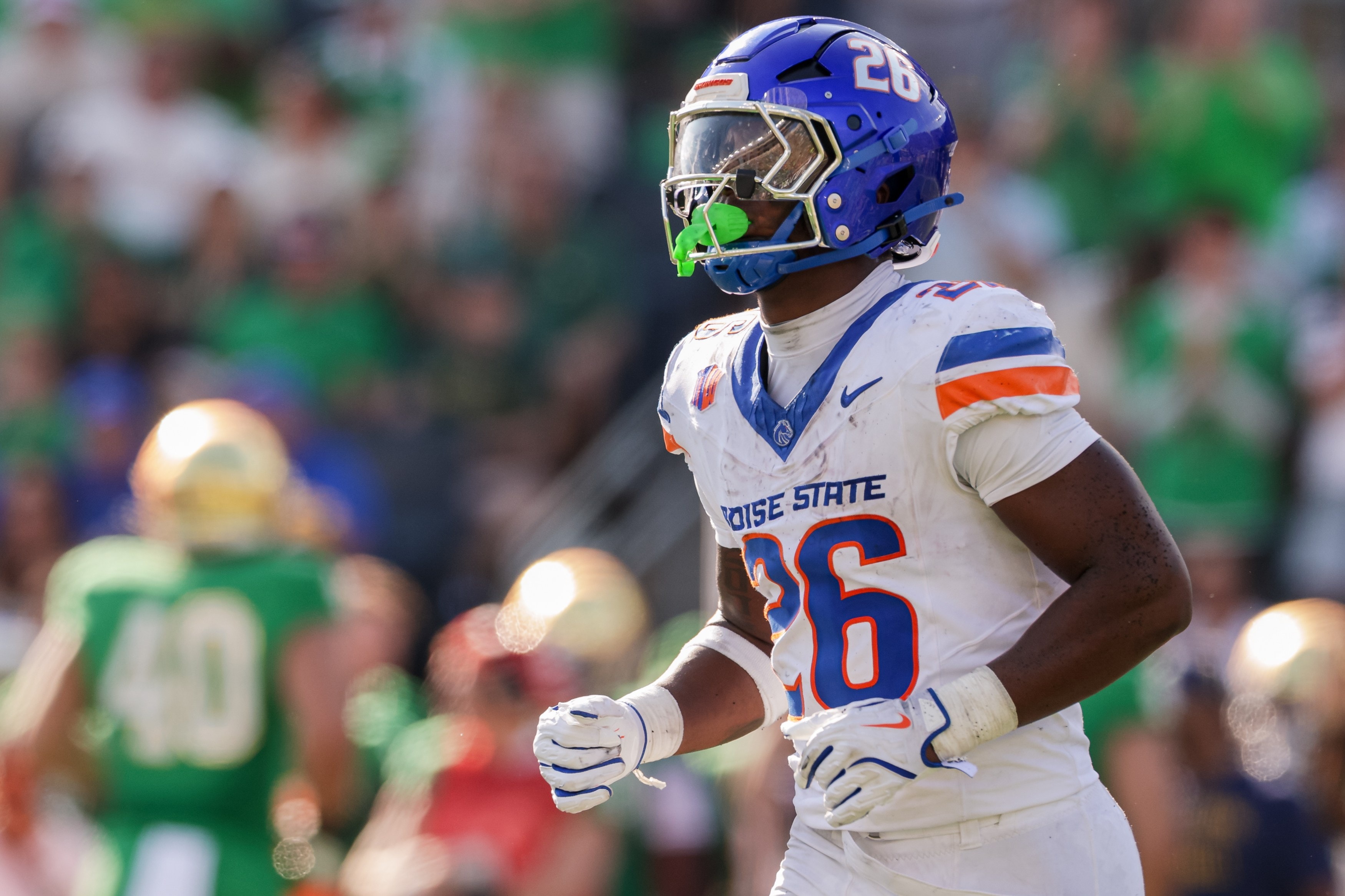 Settlement and preseason landscape shift in college football, with Mountain West share questioned and a key player returning