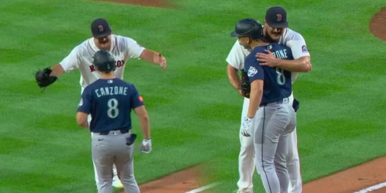 Red Sox lefty Payton Tolle gets an extra hug in, embracing Mariners DH Dominic Canzone at first base
