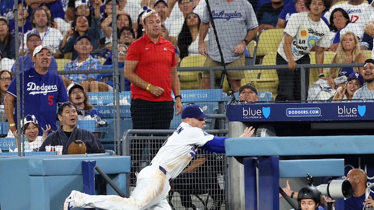 Freddie Freeman avoids serious injury after fall into Dodgers visitors’ dugout while chasing a foul popup